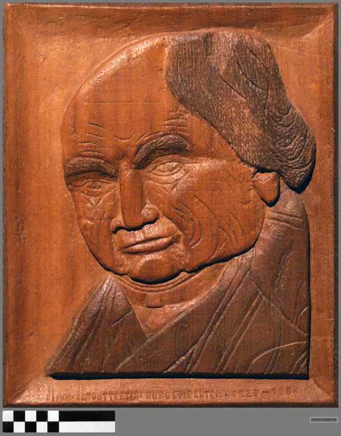 Houten paneel met in in houtsnijwerk het portret van Simon Schoutteetes